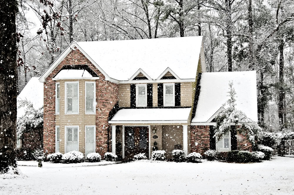 beautiful home surrounded in winter snow