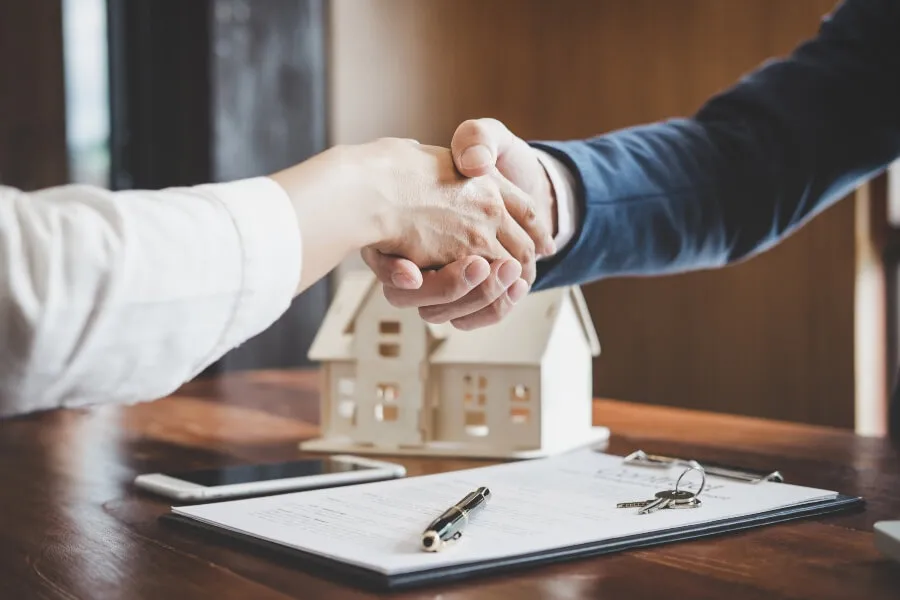 Estate agent and customer shaking hands after finished contract