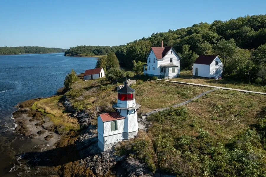 Historic Squirrel Point Light and cottage along the coastline, Phippsburg, Maine, United States.