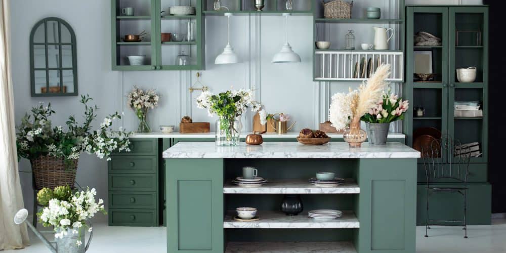 Charming kitchen with olive green cabinets and lots of fresh flowers