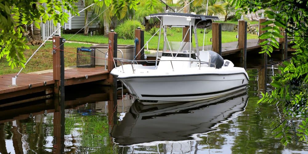Close up parked boat at dock on canal in Florida