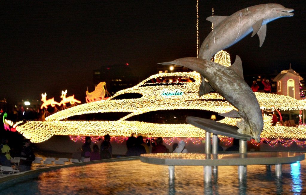 LEDE PHOTO PLEASE 12/14/02---(Photo by Nicole Fruge', digital image) A 106 foot motor yacht named Impulse passes by the dolphin sculpture at Bayfront Park during the 18th annual Boat Parade of Lights Saturday night. The boat, operated by Roy Hodges of Longboat Key, won first place in the 31 feet and over category. For more parade results click www.sarasotaparade.com. SNN will rebroadcast the parade at 8 pm Monday.