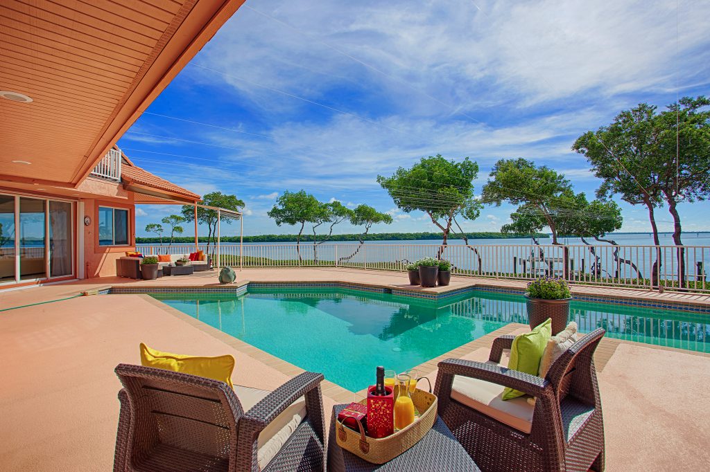 Four bedroom, pool home with 280 feet of frontage on Sarasota Bay. Longboat Key North.