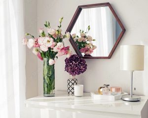 cabinet with 2 vases of pretty flowers on it