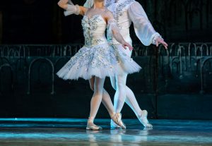 male and female ballet dancers in pose for nutcracker ballet