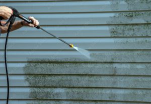exterior of siding in house being pressured washed