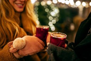 Up close view of man and women holding festive drink outdoors
