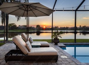 patio furniture by pool in screened patio