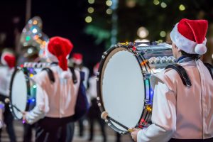 Drummers in a parade with santa hats on