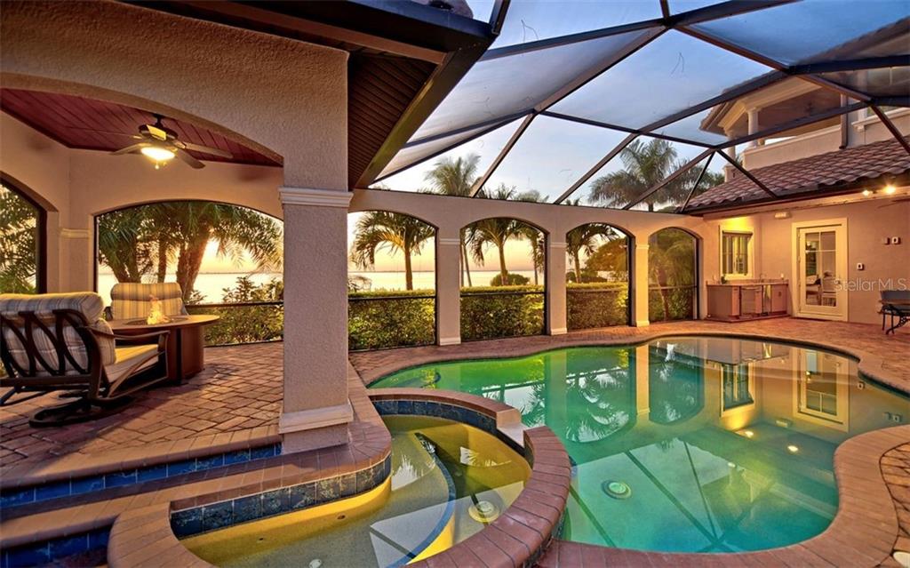 Waterfront pool lanai with firepit