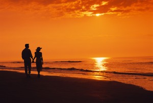 Couple Walking on Beach at Sunset