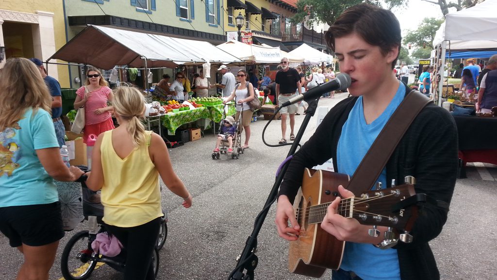 Sam Woolf sings at the Bradenton Farmer's Market. Photo courtesy Realize Bradenton.