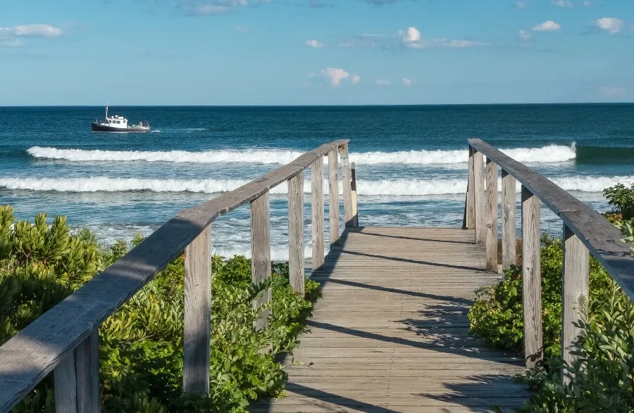 view of Laudholm beach and boat from wooden bridge, Maine