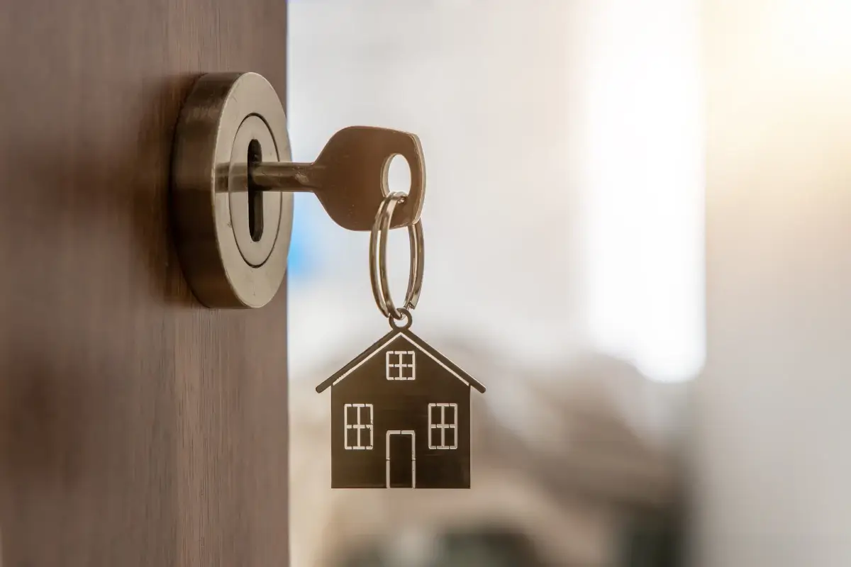 Open door to a new home with key