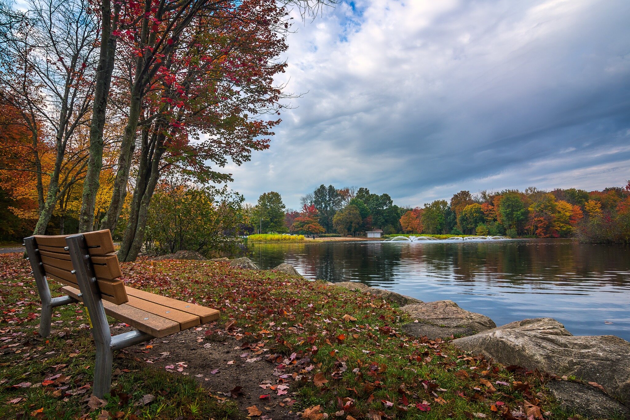 Autumn foliage around the lake at a town park in Trumbull, CT