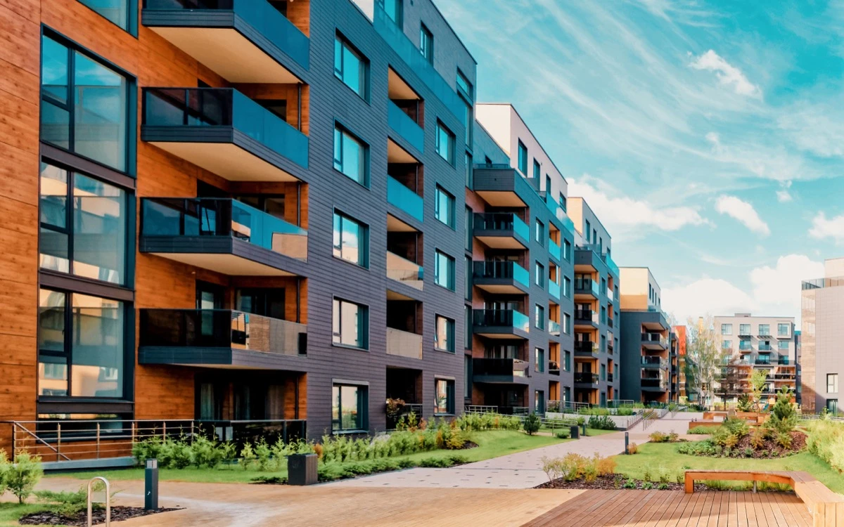 Contemporary mid-rise condo building exterior, glass and stone