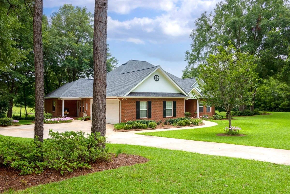 Traditional brick home, mature trees, classic style