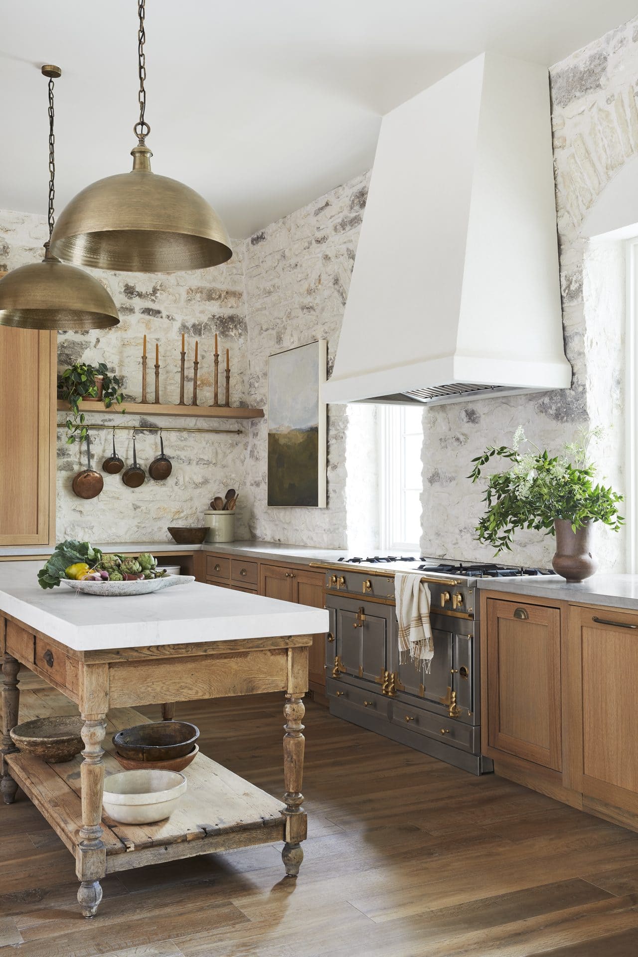 Antique island with marble countertop in rustic kitchen