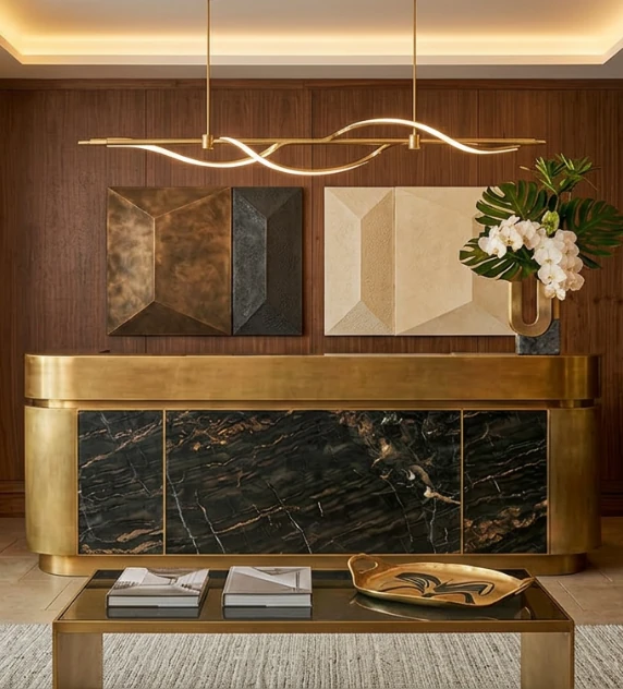 Close-up of a luxury coffee table with a glass vase of white flowers and neutral-toned books in a softly lit editorial interior setting