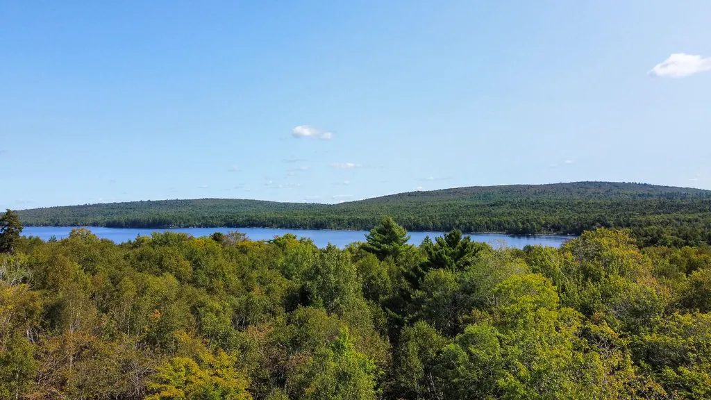 Lakefront property, serene water, wooded surroundings
