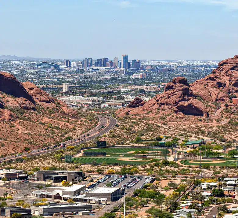 Aerial view of downtown Phoenix with the red buttes of Papago Park in the foreground
