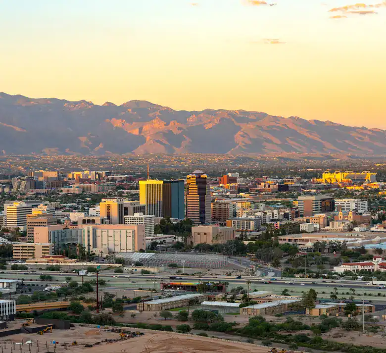 Aerial view of downtown Tucson at sunset with the Santa Catalina Mountains beyond