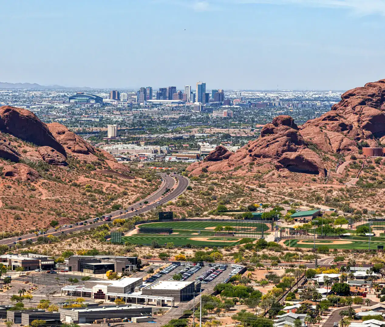 Aerial view of downtown Phoenix with the red buttes of Papago Park in the foreground