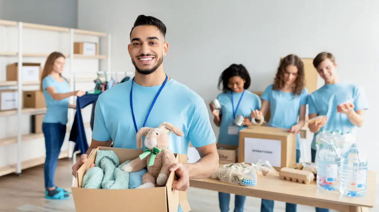 Volunteer holding a box of donated clothes