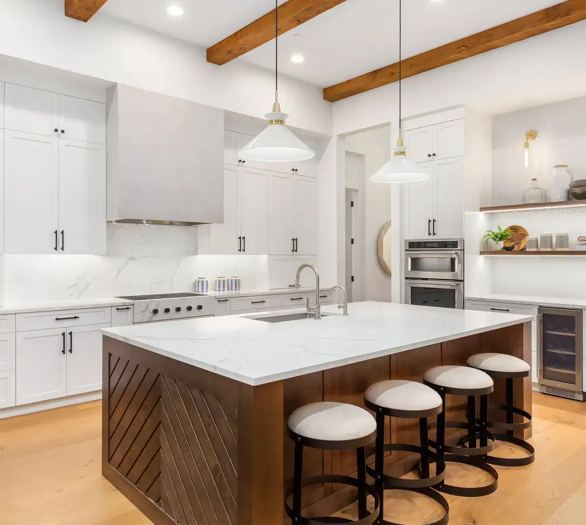 Bright white kitchen with an island and stools
