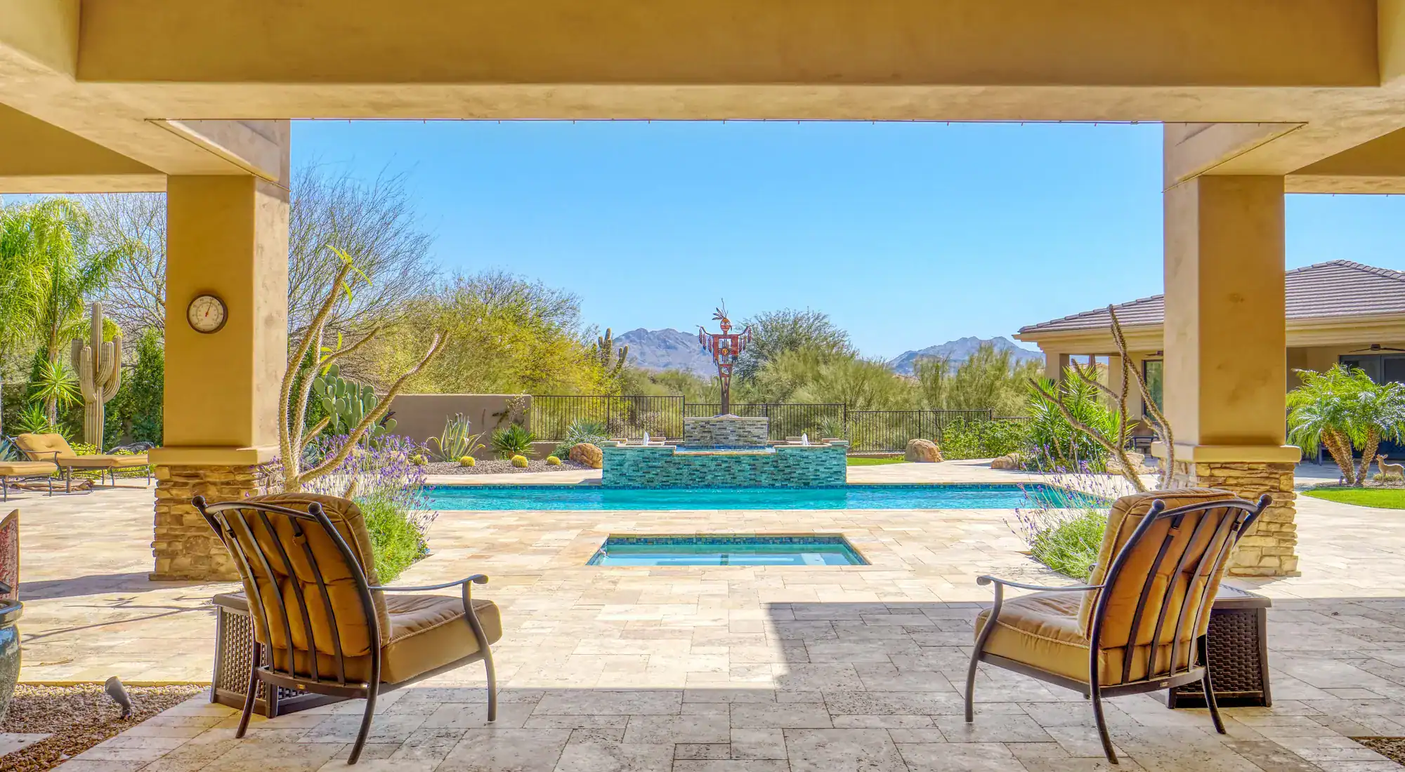 Covered back patio overlooking a pool
