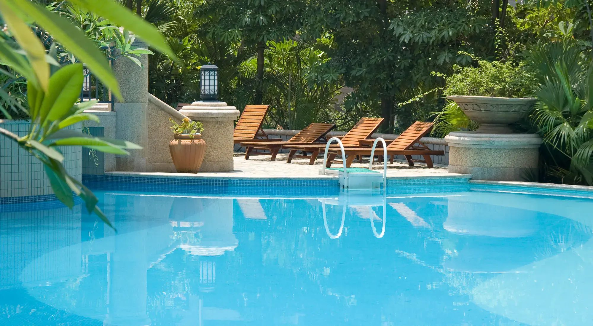 Lounge chairs beside a swimming pool