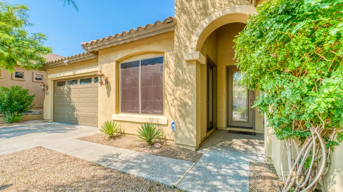 Desert-style home with an arched entry