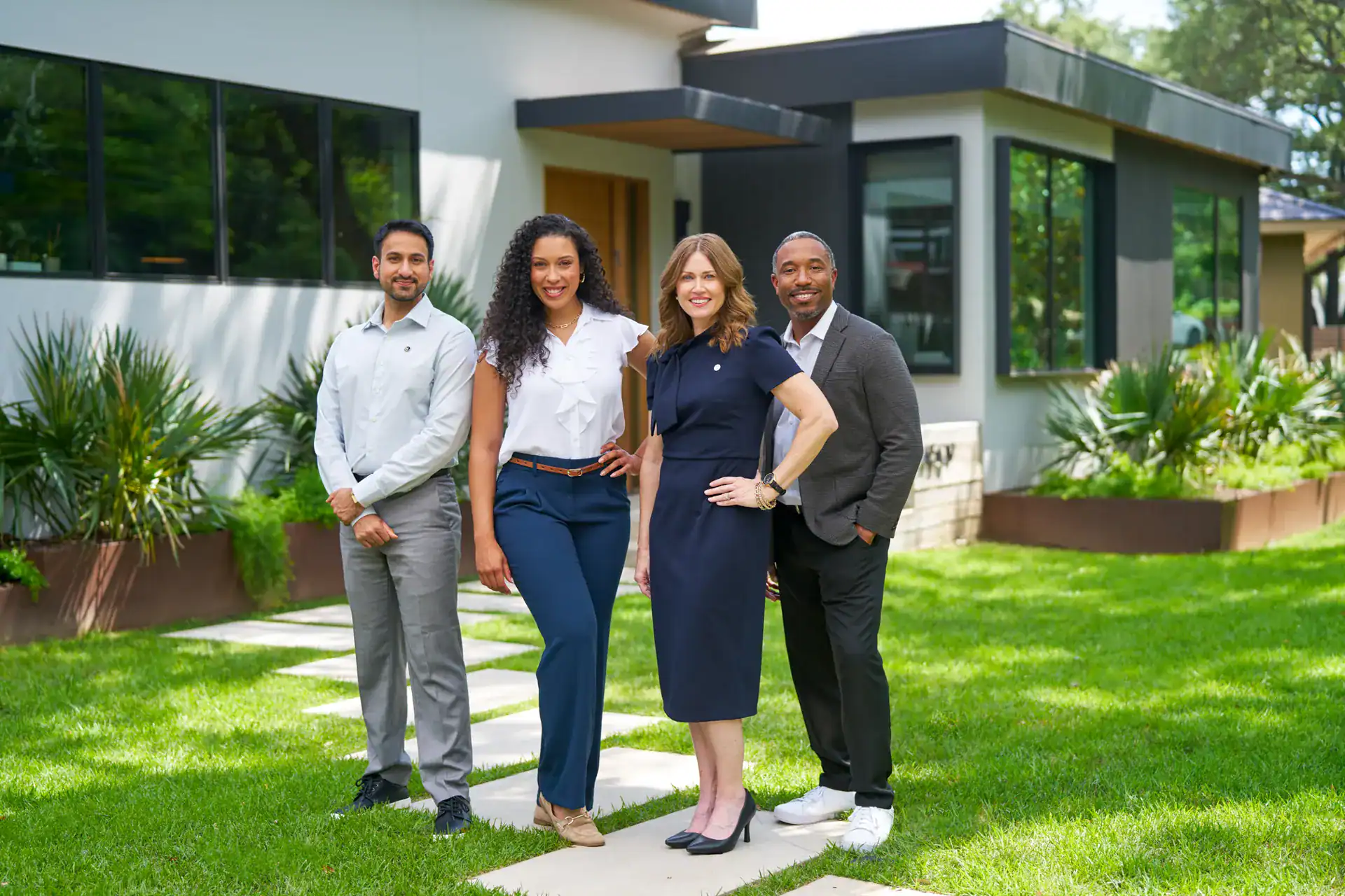 Century 21 agent team standing outside a modern home