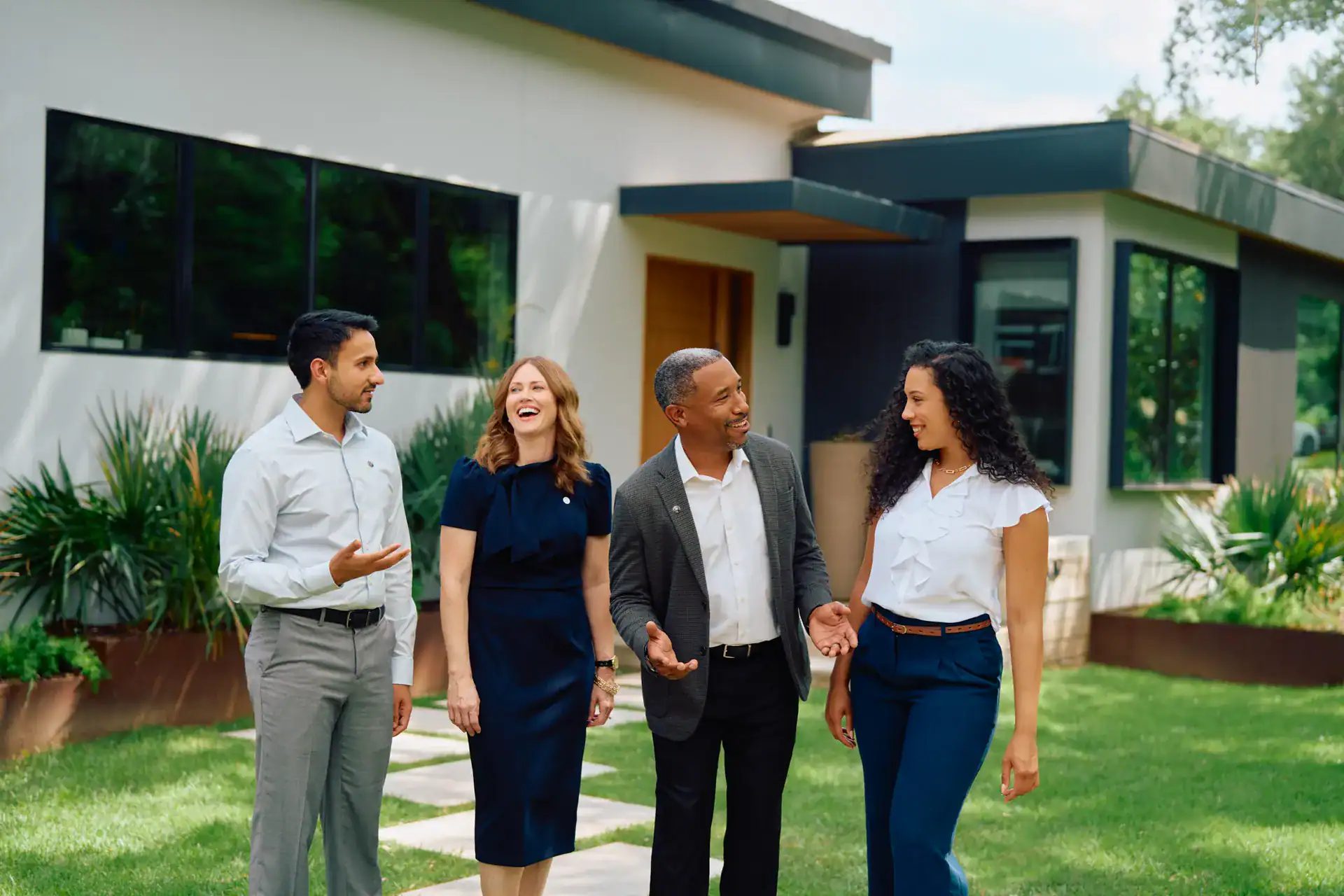 Century 21 agents talking together outside a modern home