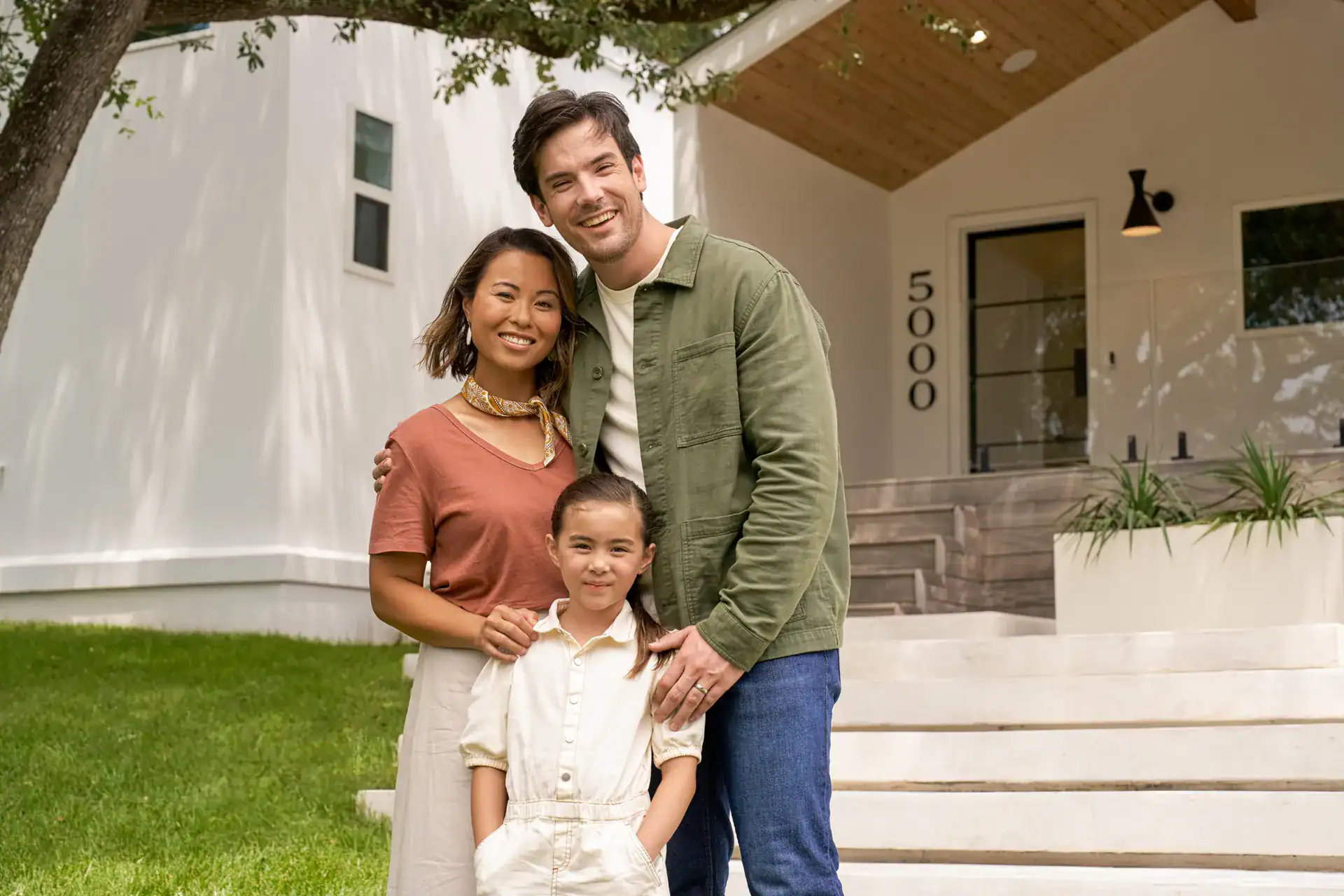 Family standing outside their new home