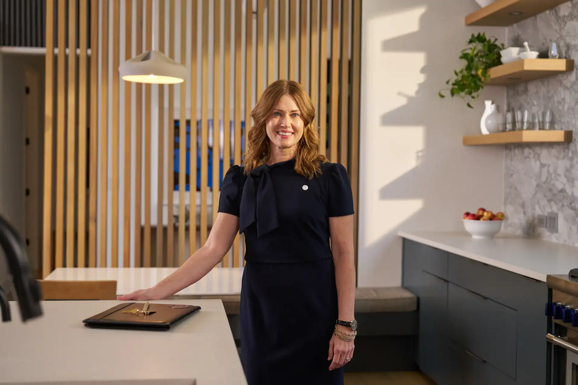 Century 21 agent standing at a kitchen island