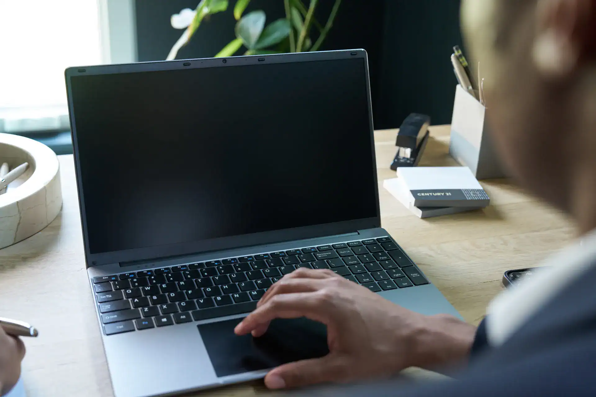 Agent working on a laptop at a desk