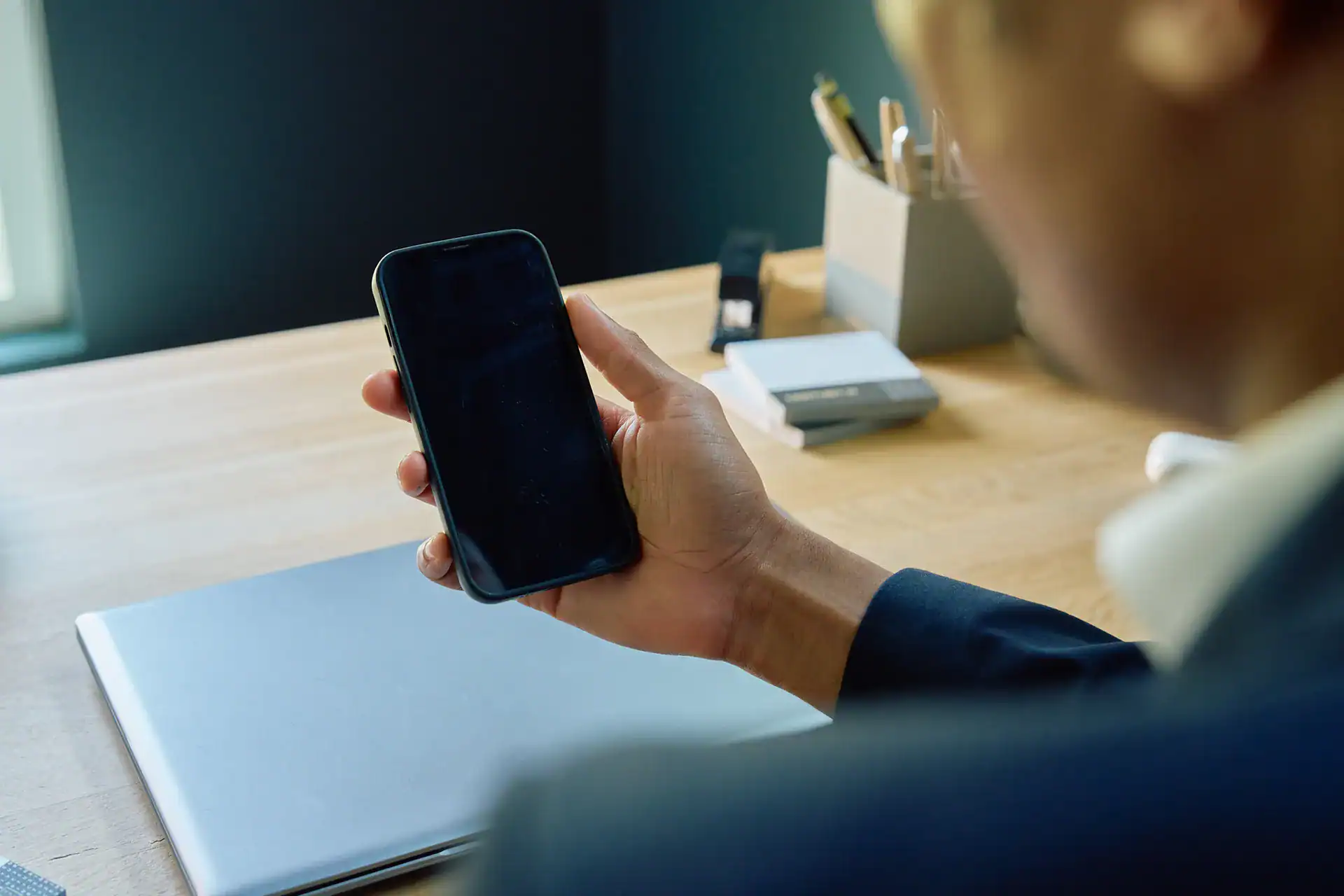 Agent checking a phone at a desk