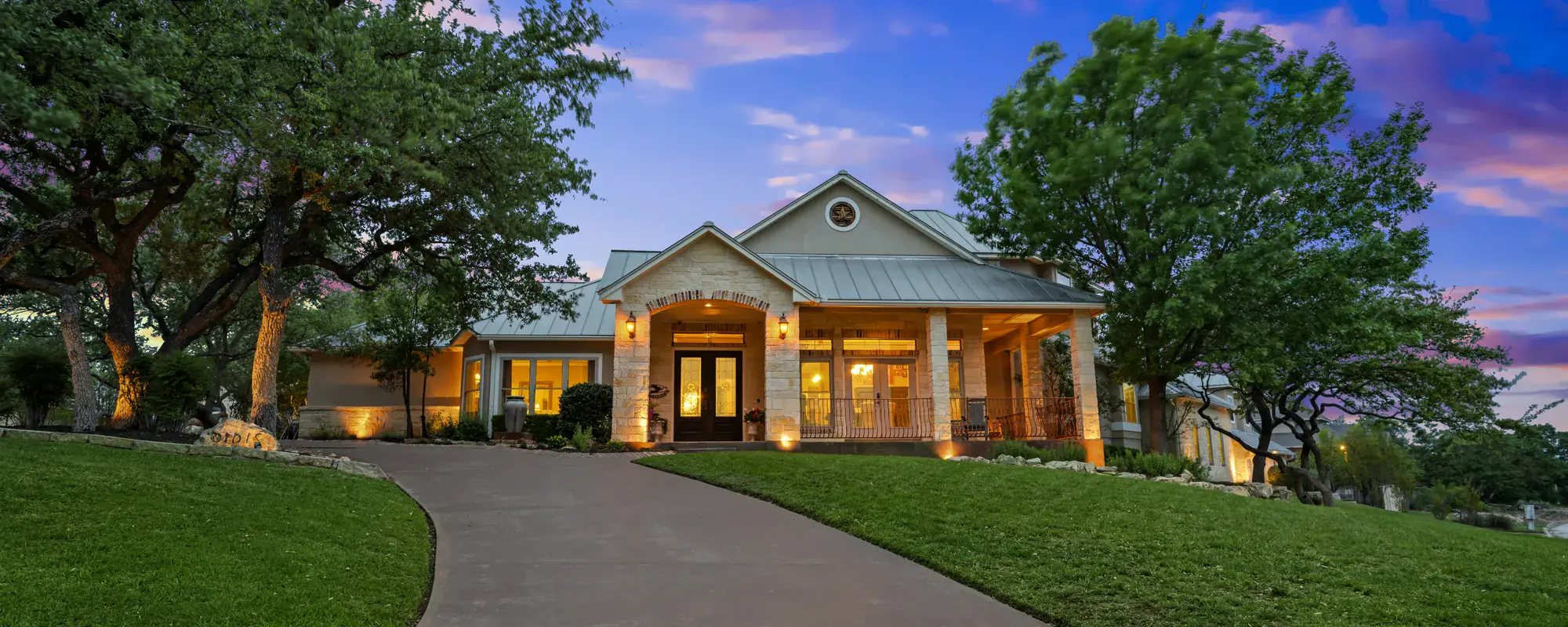 Home exterior lit at sunset