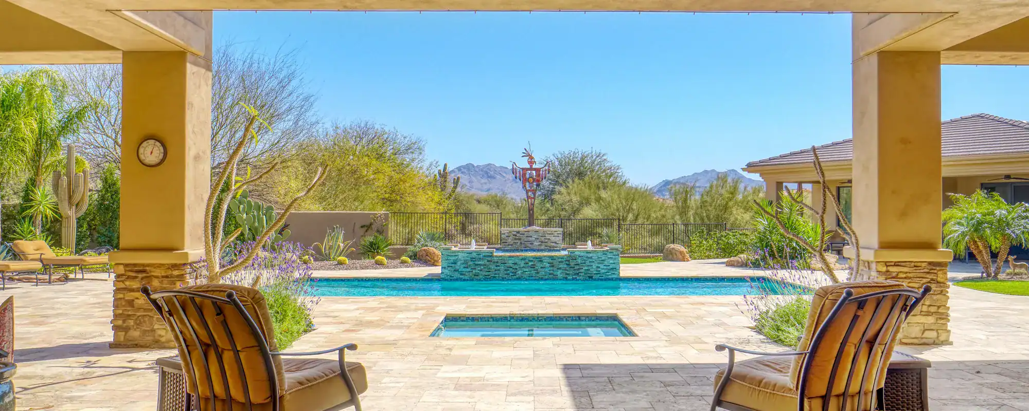 Covered back patio overlooking a pool