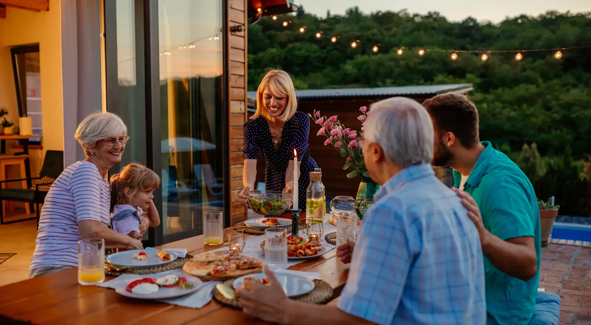 Three generations sharing dinner outdoors