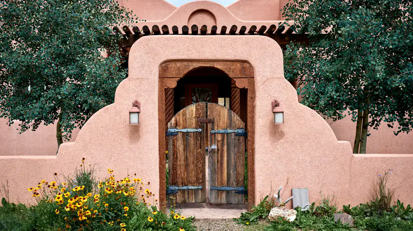 Adobe wall with a wooden gate