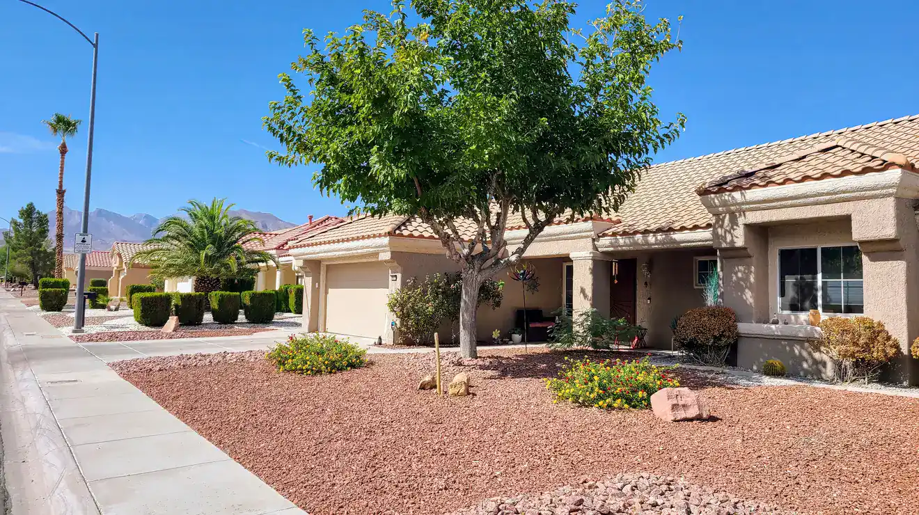 Desert home and landscaping with a mountain view