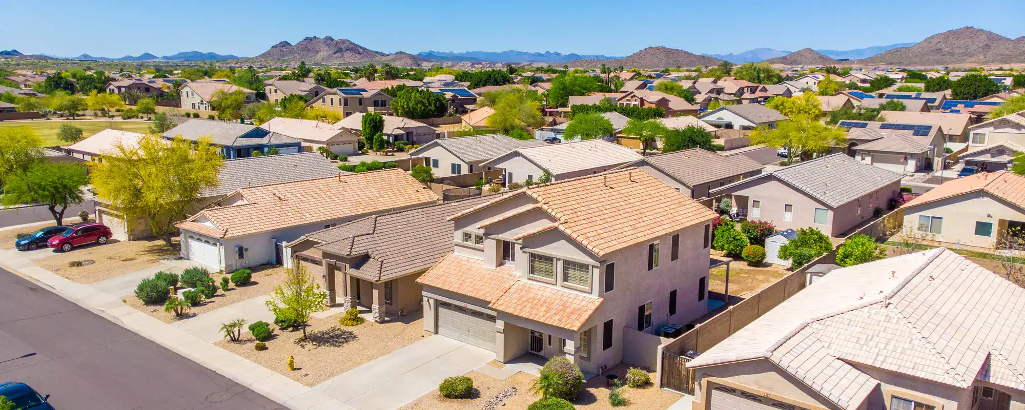 Arizona neighborhood of tile-roof homes and mountains