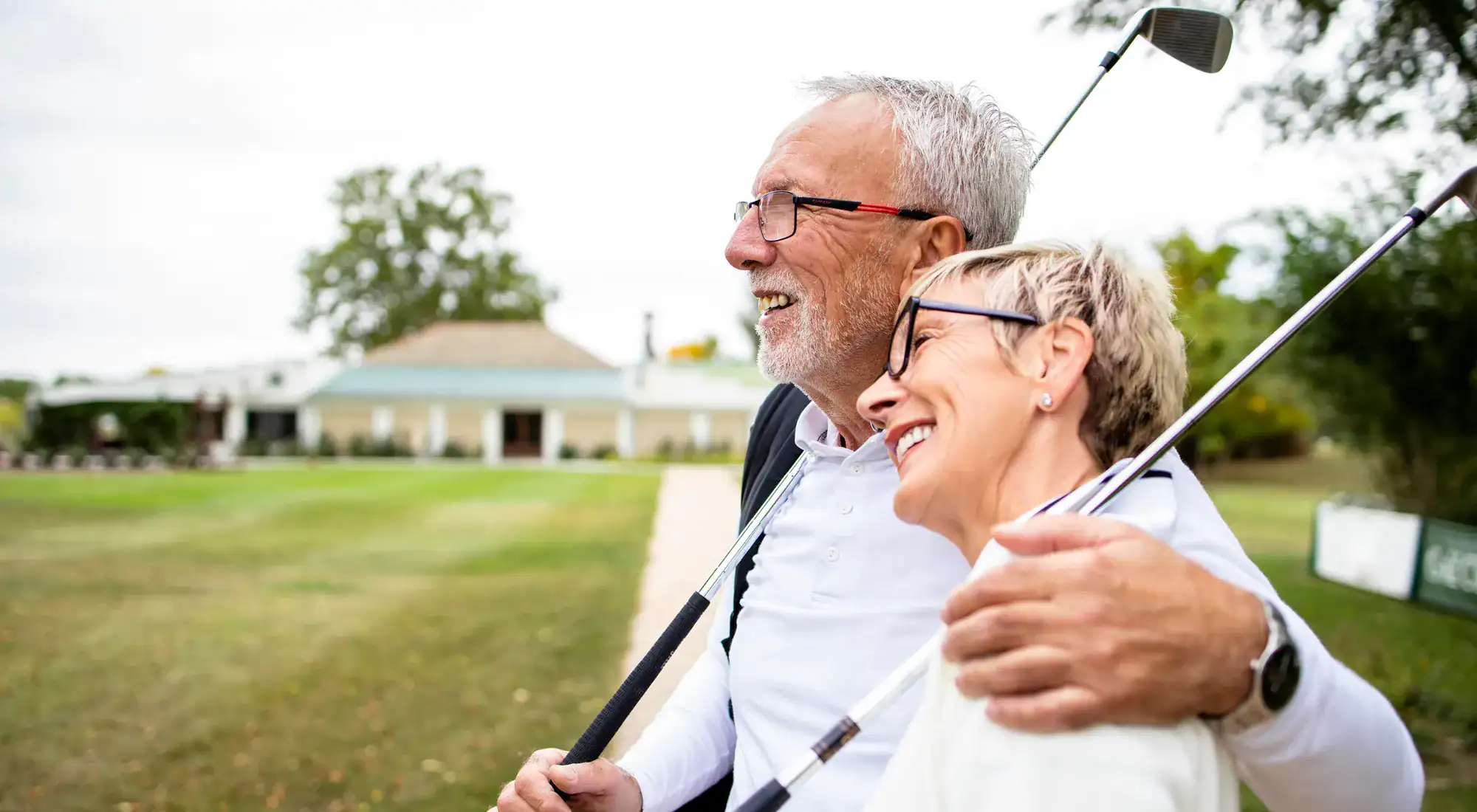 Senior couple embracing on a golf course