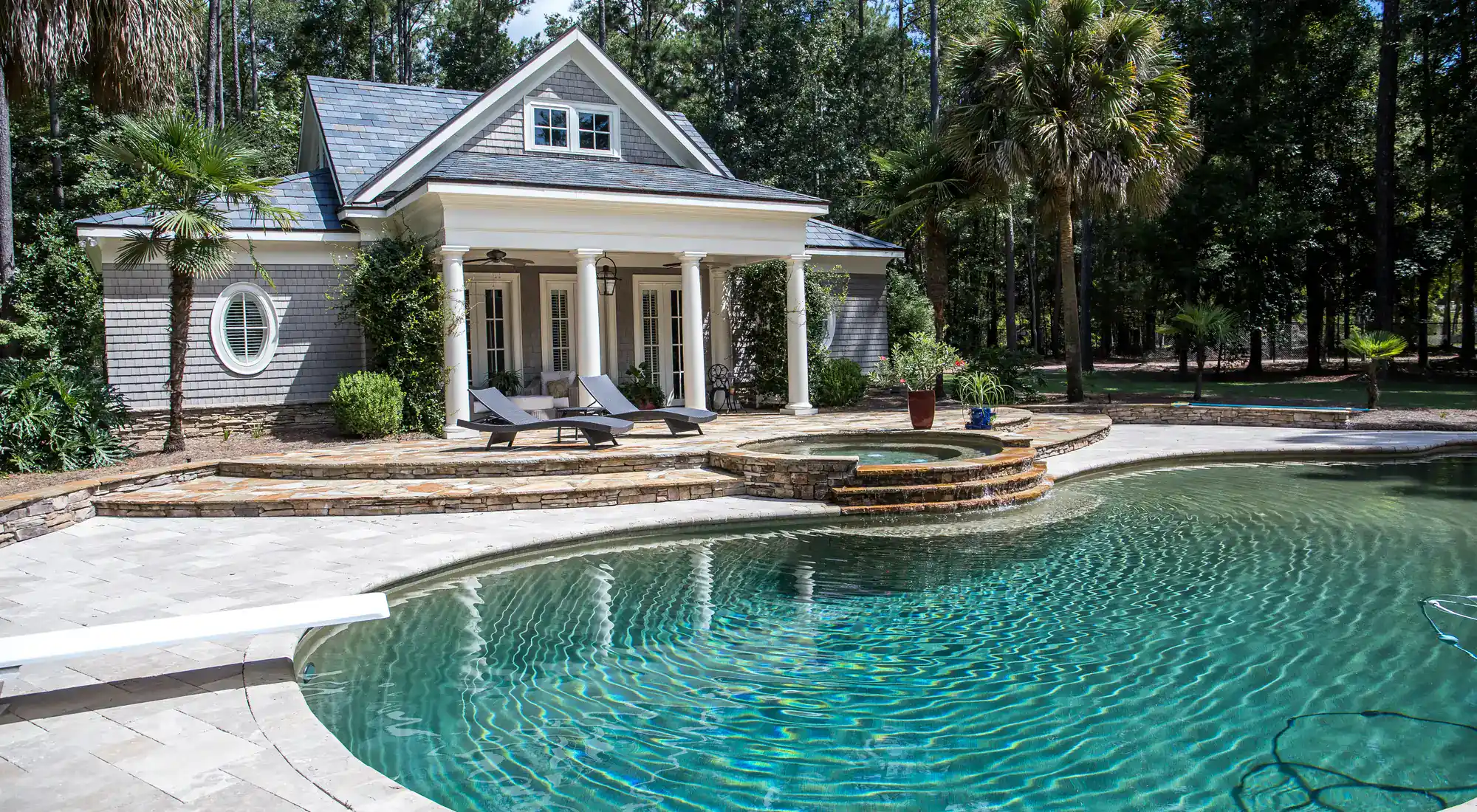 Pool house beside a large swimming pool