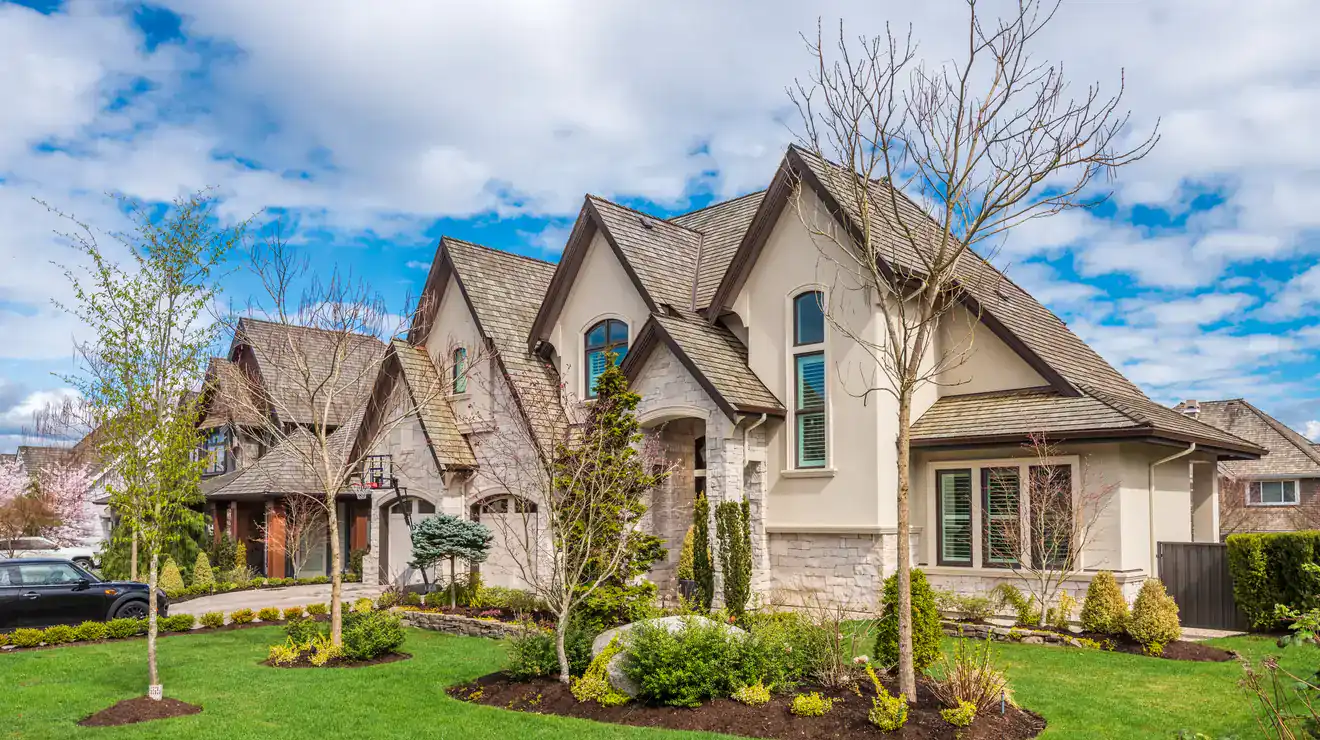 Two-story home exterior with a landscaped yard