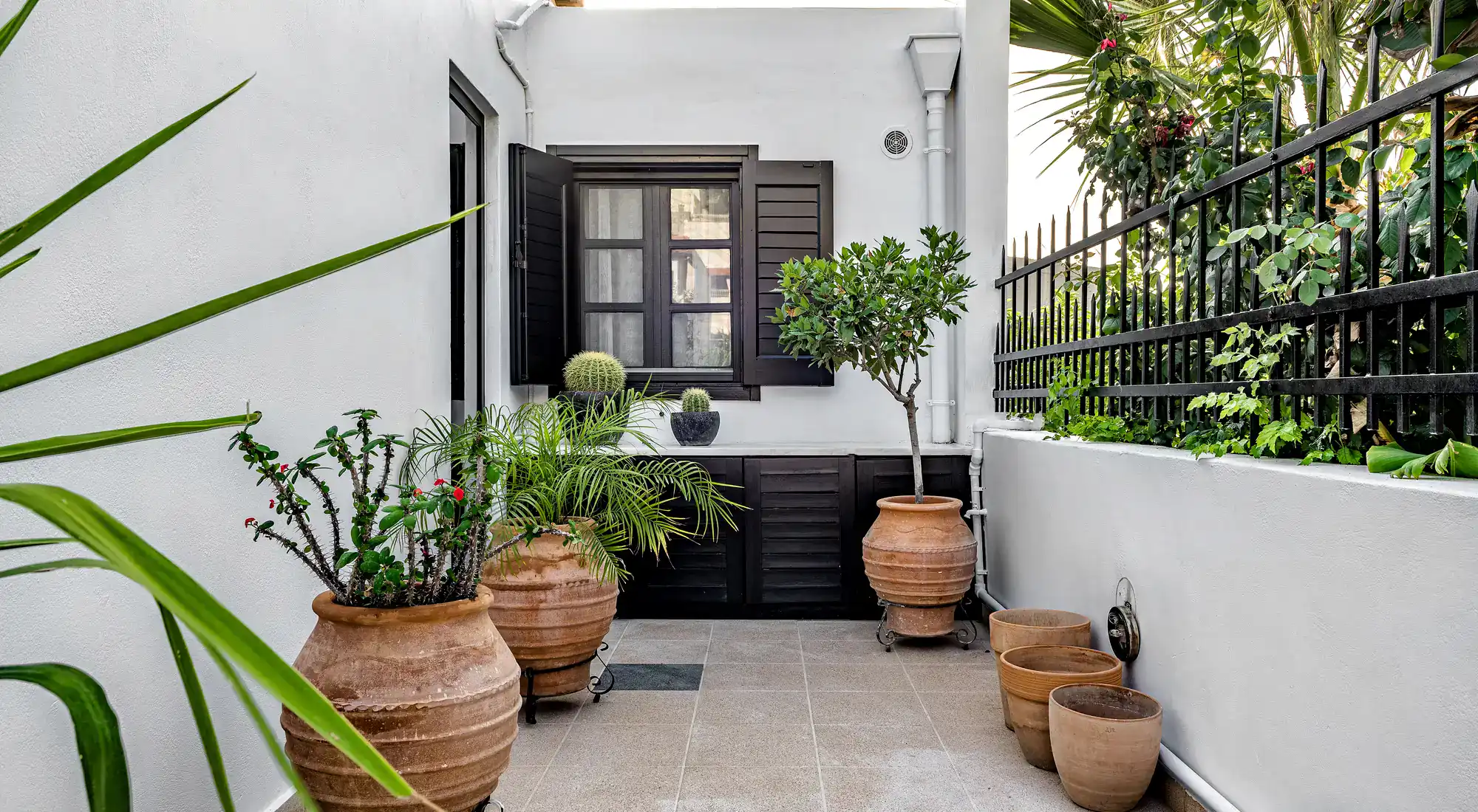 Small tiled terrace with flower pots