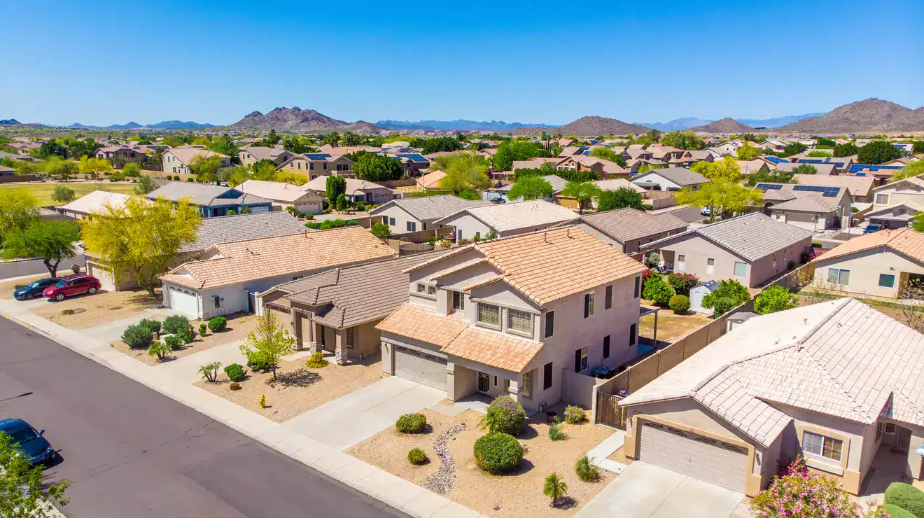 Arizona neighborhood of tile-roof homes and mountains