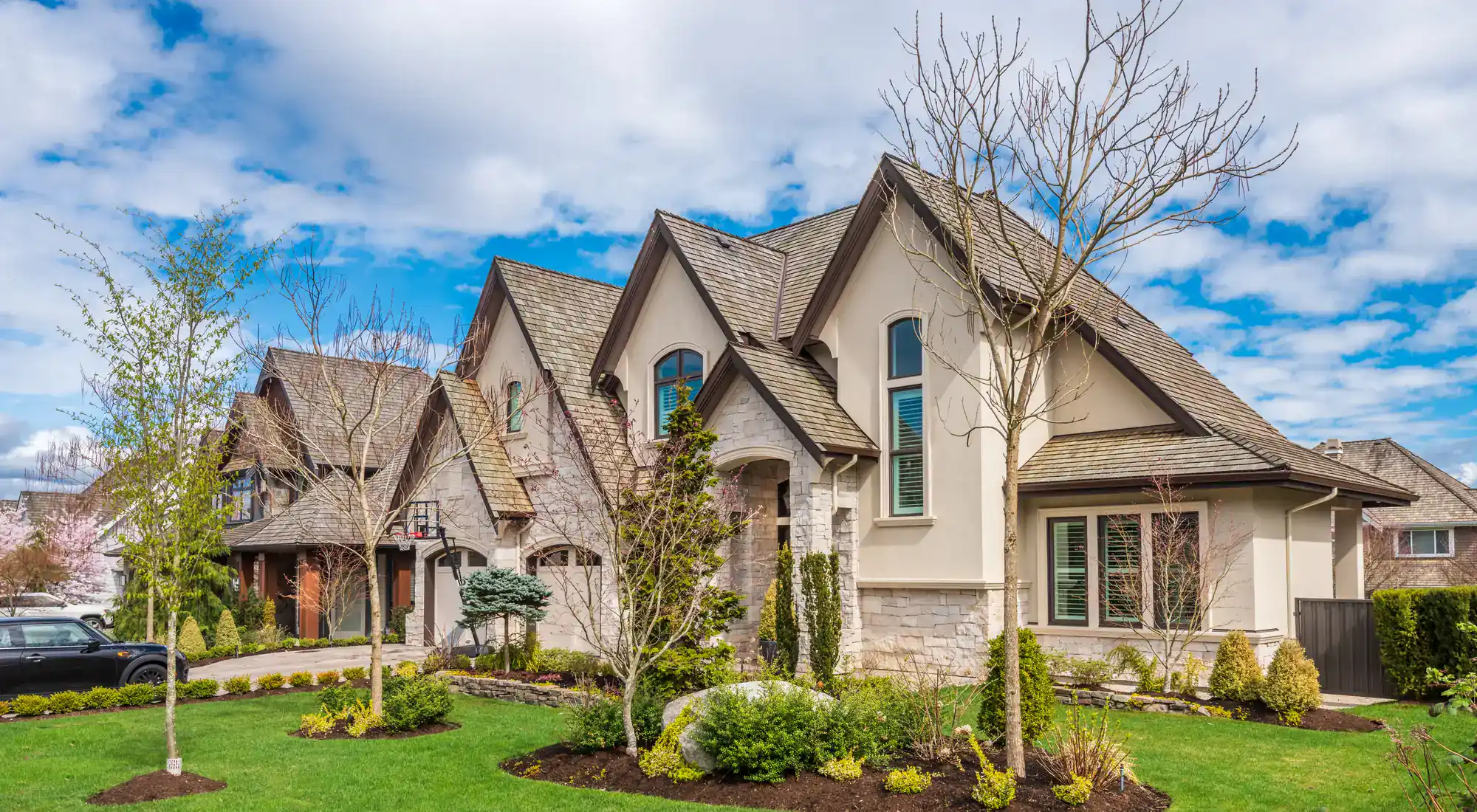 Two-story home exterior with a landscaped yard